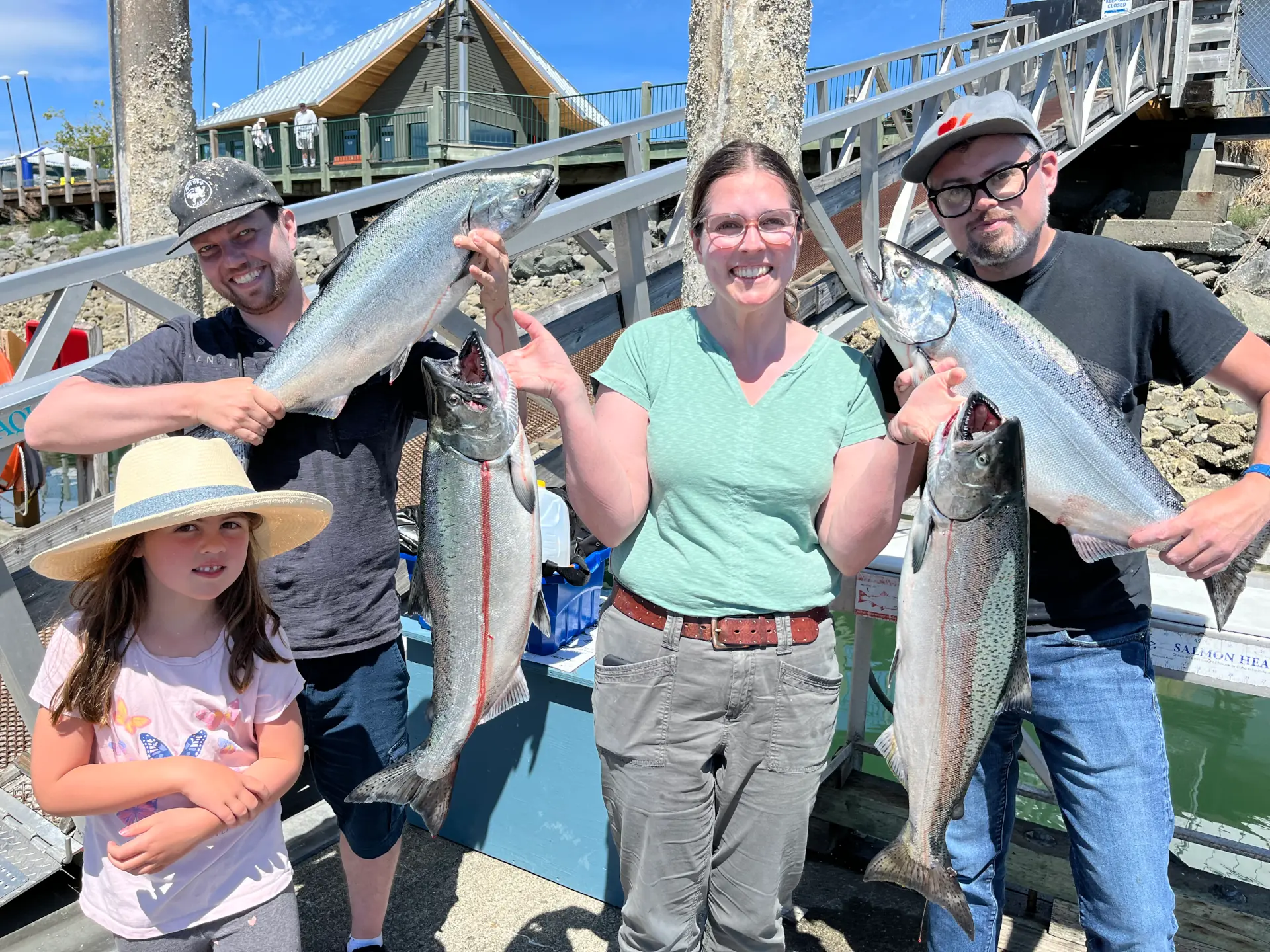 family showing the salmon they caught near Comox