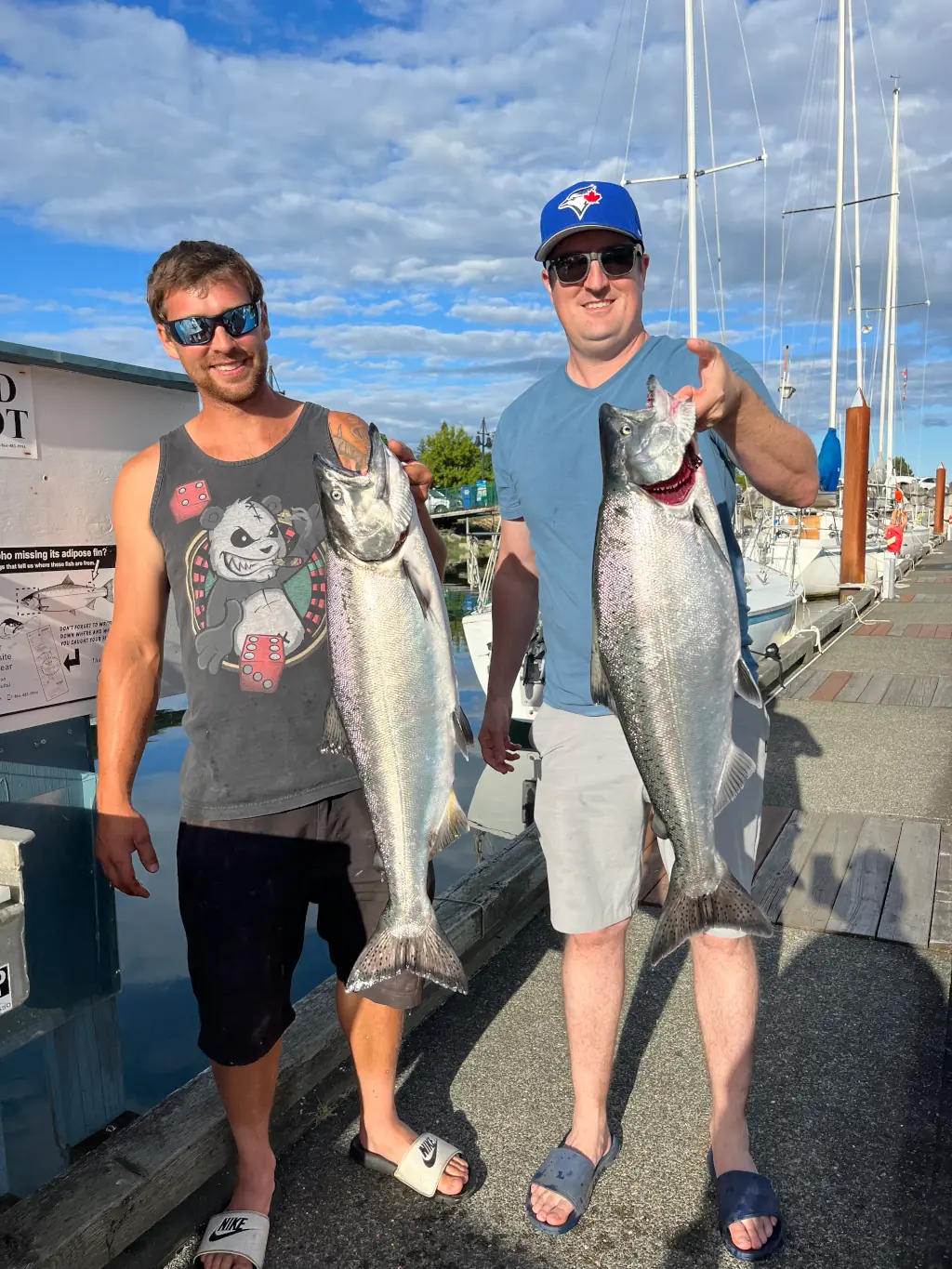 two men displaying the large salmon they caught with Cliff's Charters