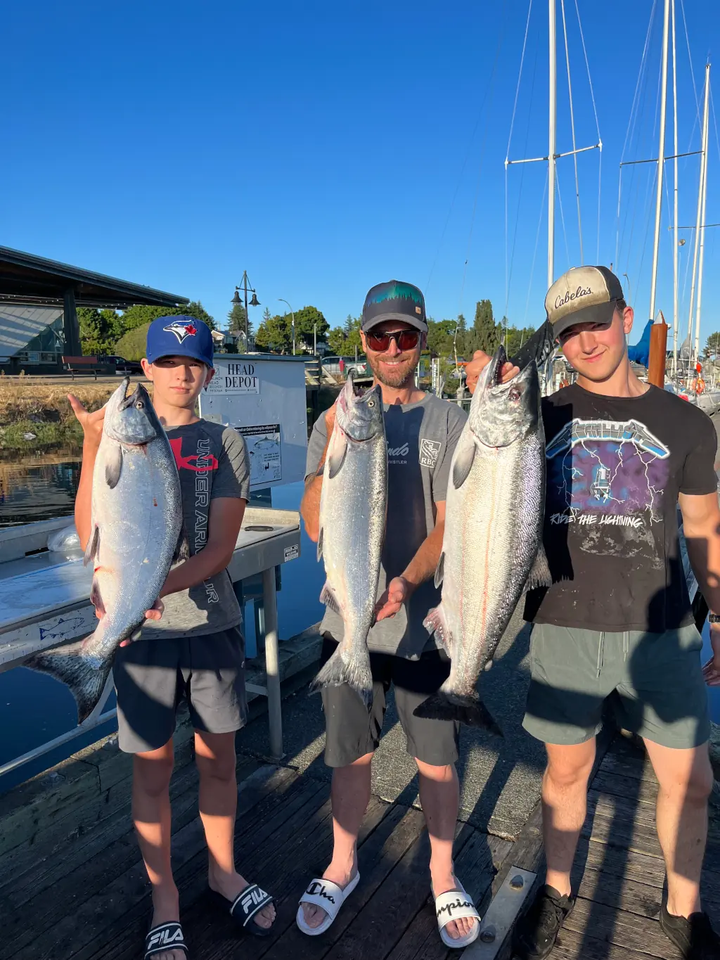 3 guys showing off the fish they caught near Comox