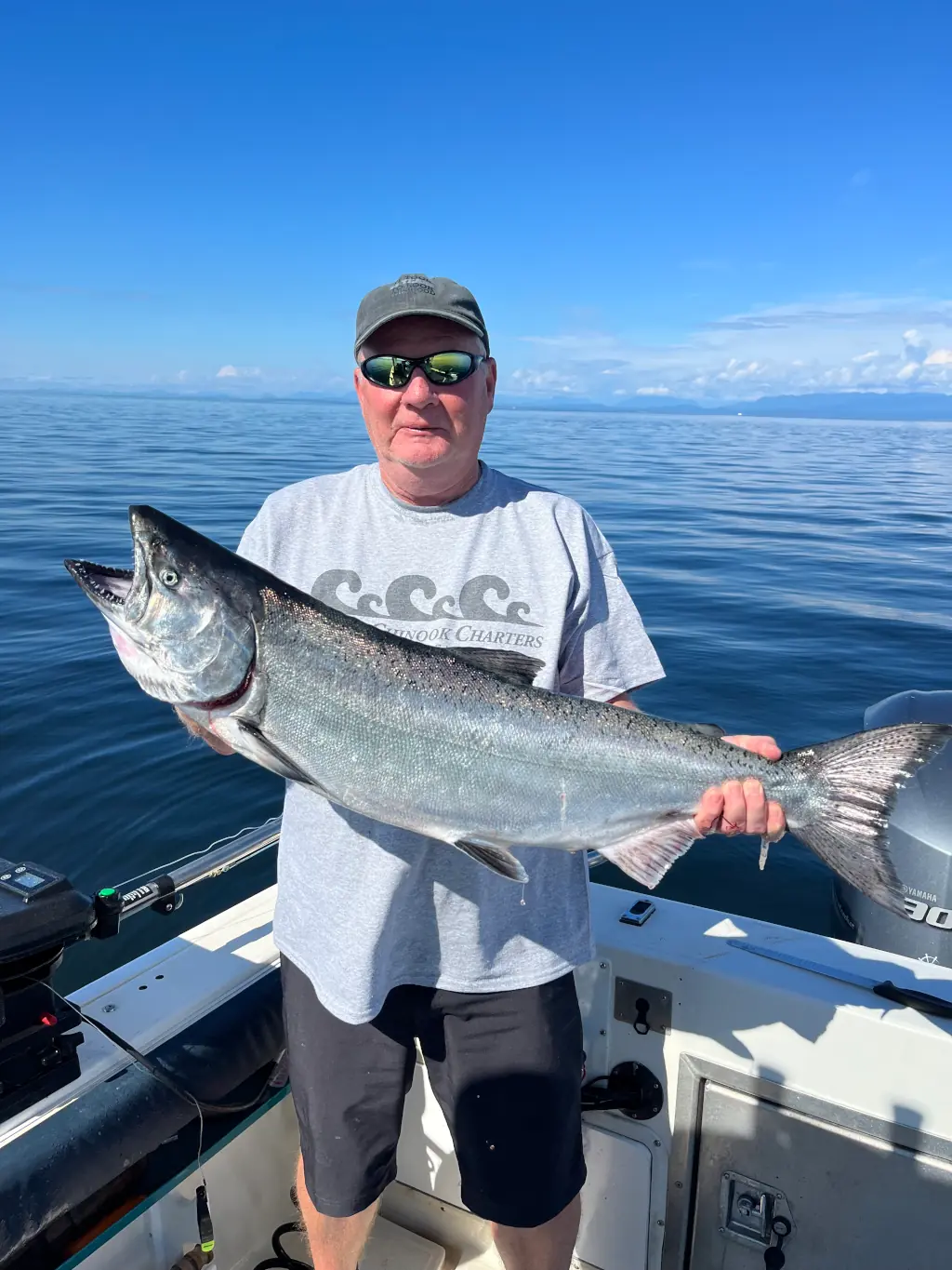 man displaying a large salmon caught with Cliff's Chinook Charters