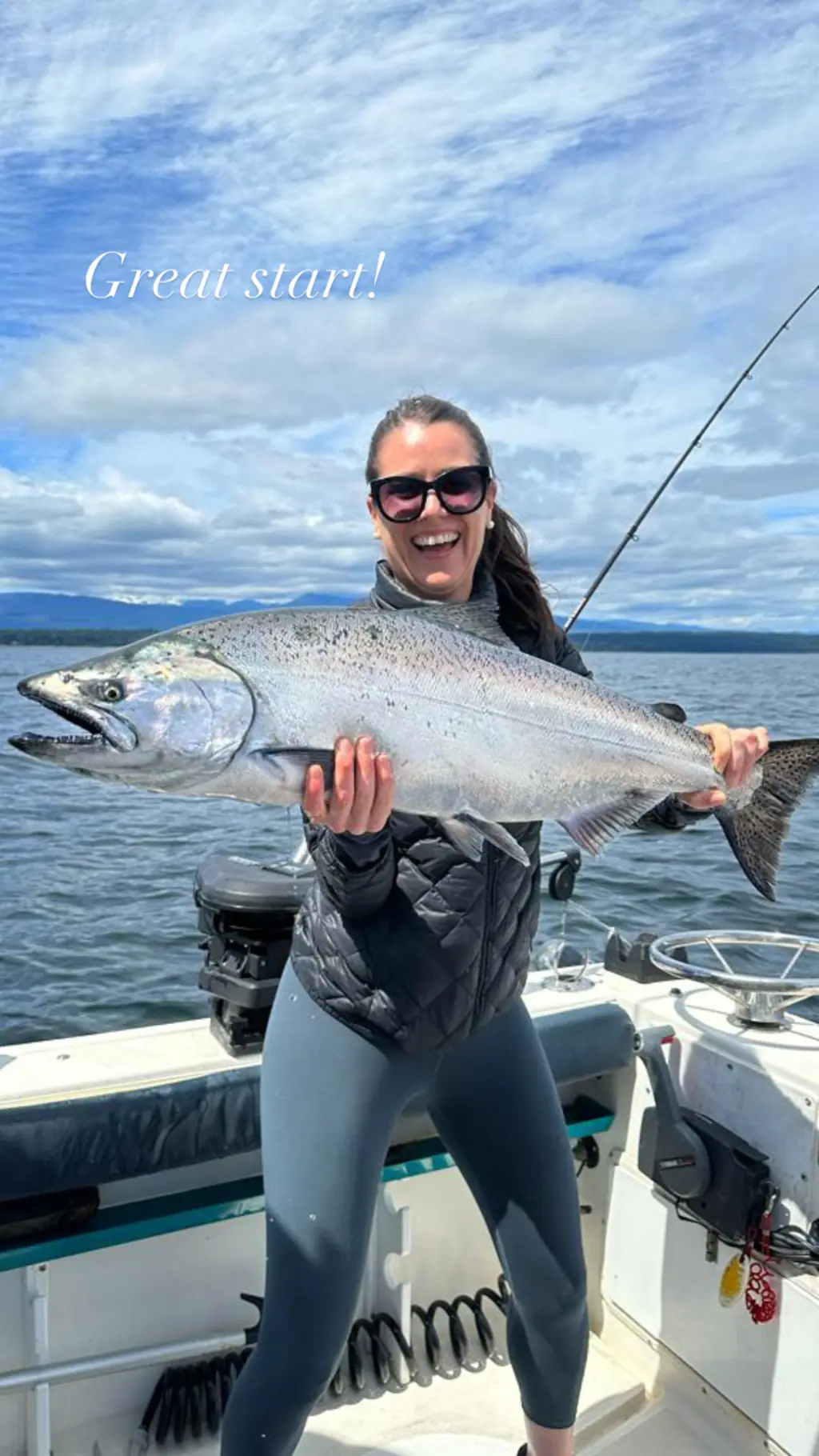 woman proudly showing off her huge salmon