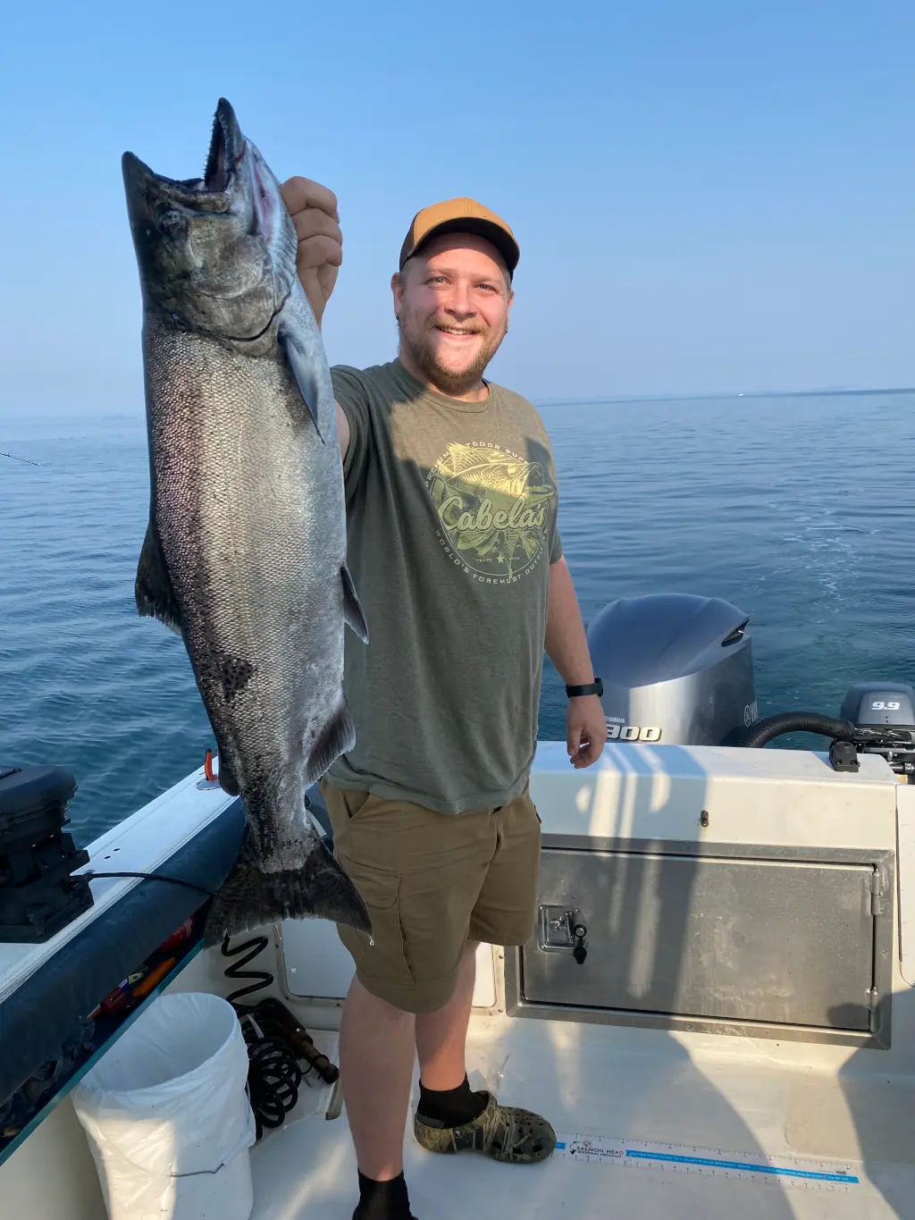 man displaying salmon caught on a guided fishing expedition