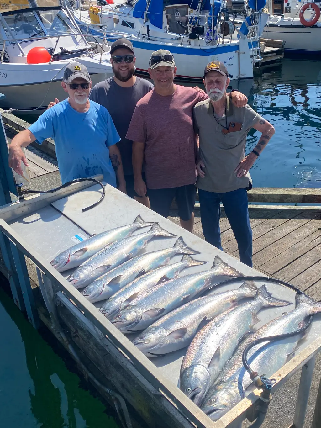 group showing off their haul of fishing at the Comox dock