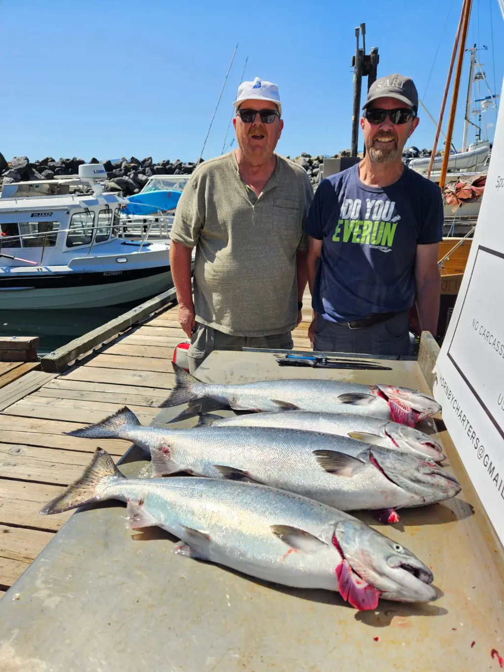 two men showing off their catch in Comox