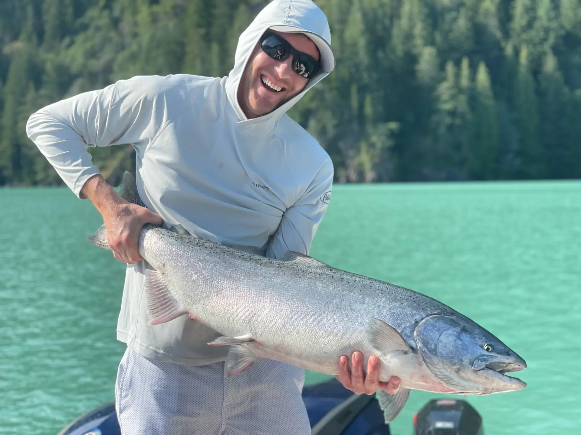 man displaying a large salmon caught off Quadra Island