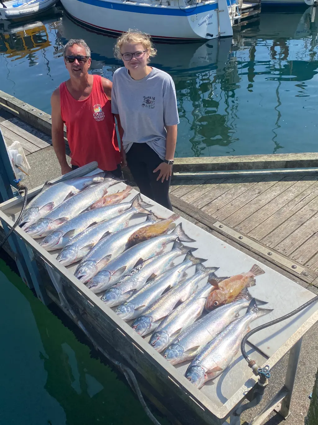 friends displaying all the salmon they caught with Cliff's Chinook Charters