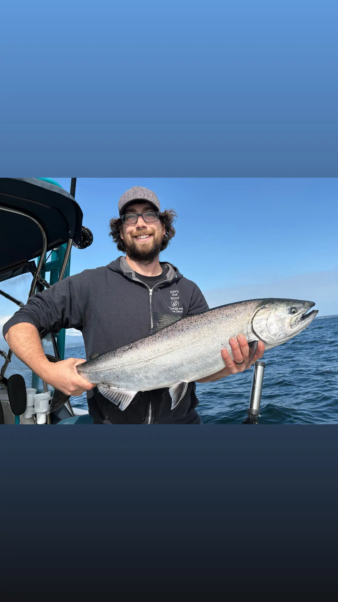 man displaying a large salmon caught near Campbell River