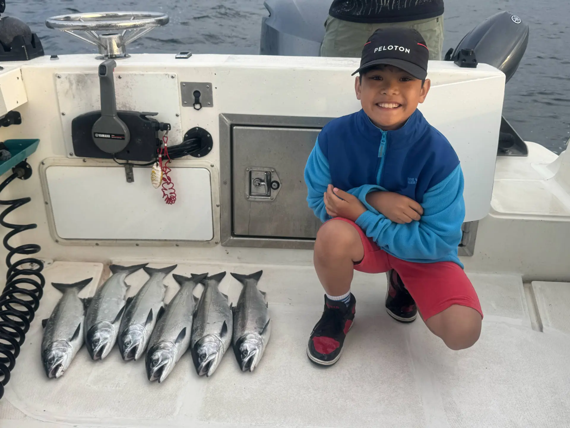 child showing off his catch with Cliff's Fishing Charters