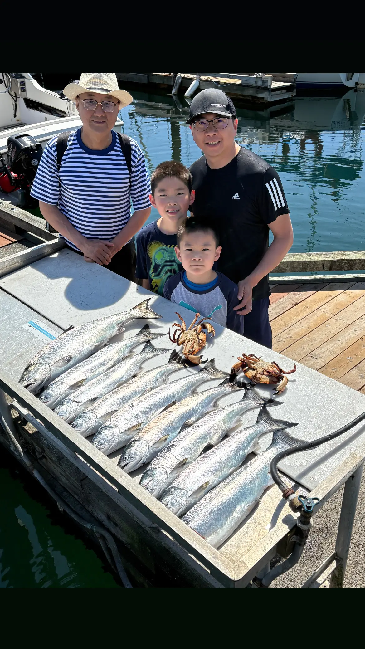family displaying the fish they caught off Comox