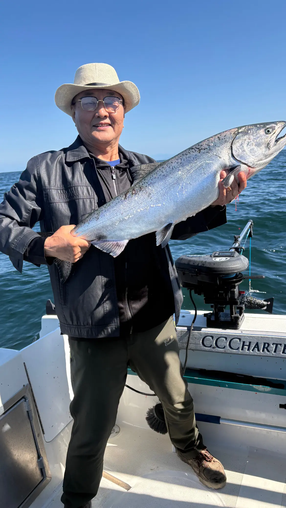 man displaying a giant salmon caught near Hornby Island
